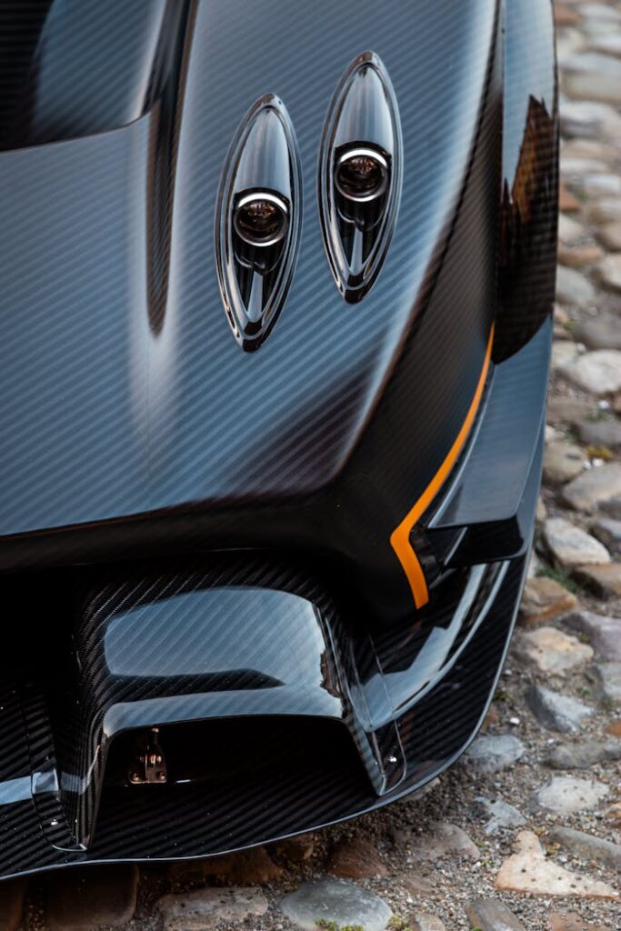 Close-up view of hypercar's sleek carbon fiber design showcasing intricate engineering.